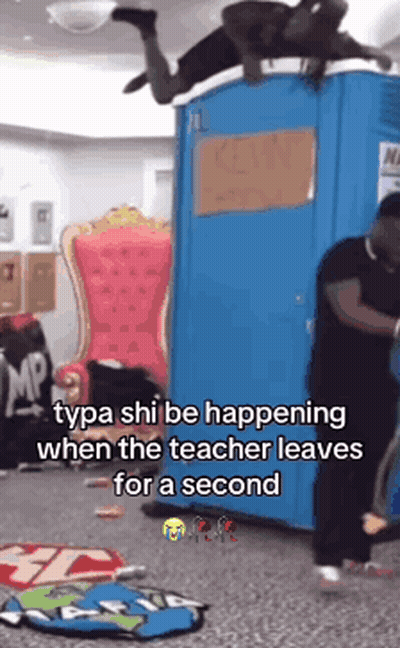 A Man Is Laying On Top Of A Blue Portable Toilet While The Teacher Leaves For A Second . GIF