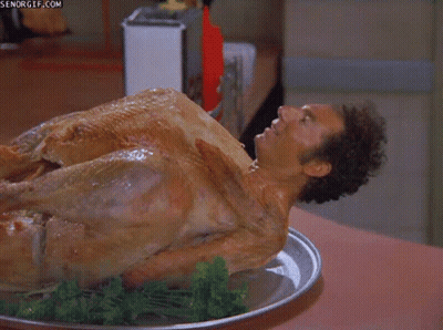 A Man Is Laying On Top Of A Turkey On A Tray GIF