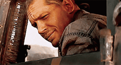 A Man Is Leaning His Head Out Of A Window And Smiling .. GIF