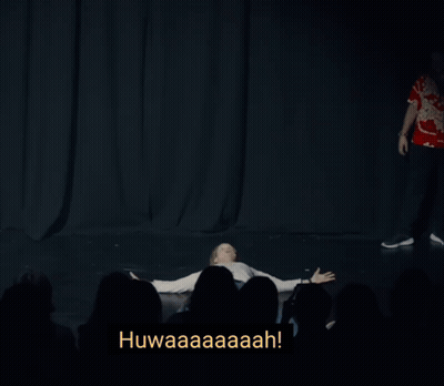 A Man Is Levitating In Front Of A Crowd With The Words Levitating Below Him GIF