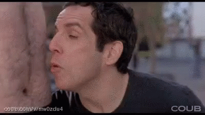 A Man Is Licking Another Man 'S Ear In A Movie Scene . GIF
