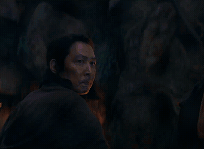 A Man Is Looking At A Blue Light Beam GIF