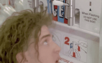 A Man Is Looking At A Sign That Says " When Flashing Do Not Use This Side " GIF