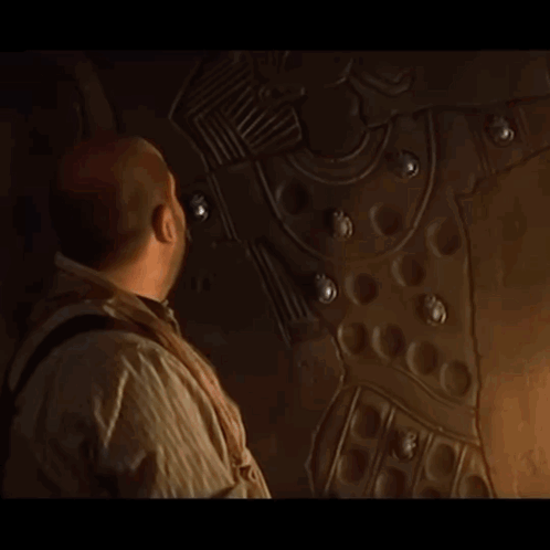 A Man Is Looking At A Wall With A Drawing On It GIF