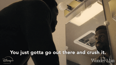 A Man Is Looking At Himself In A Mirror With The Words You Just Gotta Go Out There And Crush It GIF