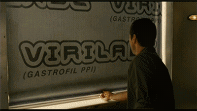 A Man Is Looking Out A Window At A Sign That Says Virulog GIF