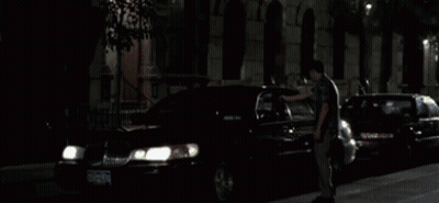 A Man Is Looking Out Of A Window With A Blurry Background Of Arrows GIF