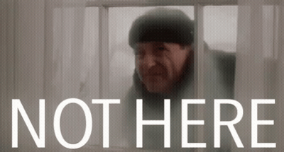 A Man Is Looking Out Of A Window With The Words Not Here Behind Him GIF