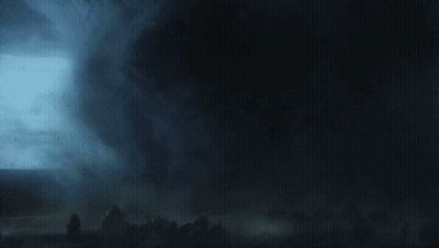 A Man Is Looking Through A Camera Lens That Says ' Canon ' On It GIF