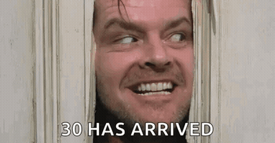 A Man Is Looking Through A Door With The Words `` 30 Has Arrived '' Written Below Him . GIF