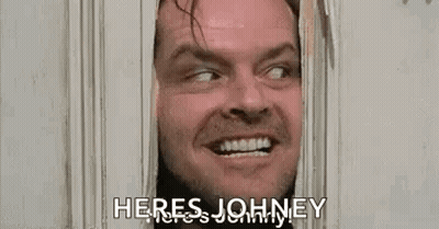 A Man Is Looking Through A Door With The Words `` Here 'S Johnny '' . GIF