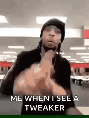 A Man Is Making A Funny Face And Giving The Middle Finger . GIF
