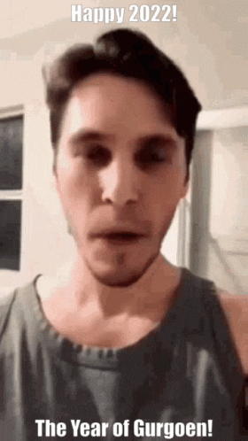 A Man Is Making A Funny Face And Says Happy 2022 The Year Of Gurgoen ! GIF