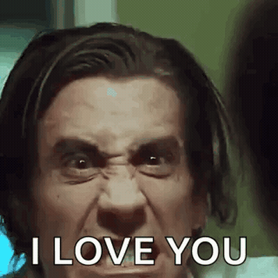 A Man Is Making A Funny Face And Says `` I Love You '' . GIF