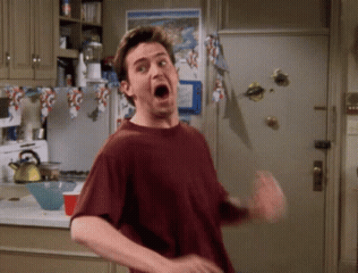 A Man Is Making A Funny Face In A Kitchen GIF