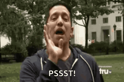 A Man Is Making A Funny Face In A Park With His Hand On His Face . GIF