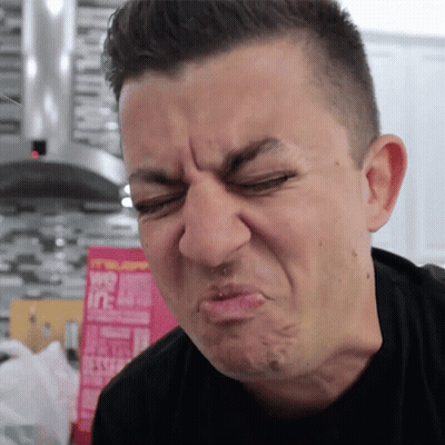 A Man Is Making A Funny Face In Front Of A Box That Says ' Oats ' On It GIF