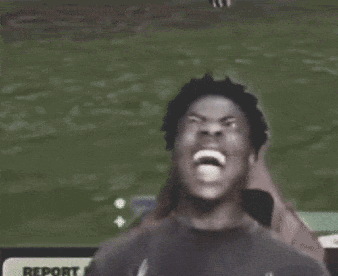 A Man Is Making A Funny Face In Front Of A Report Sign . GIF