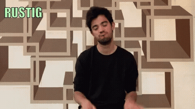 A Man Is Making A Funny Face In Front Of A Wall That Says Rustic GIF