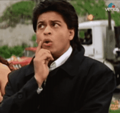 A Man Is Making A Funny Face While Holding His Finger To His Lips . GIF