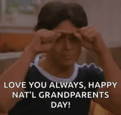 A Man Is Making A Funny Face While Holding His Hands To His Eyes . GIF