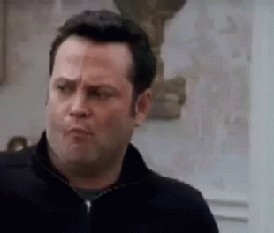 A Man Is Making A Funny Face While Looking At The Camera . GIF