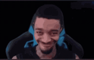 A Man Is Making A Funny Face While Sitting In A Chair In Front Of A Black Background . GIF
