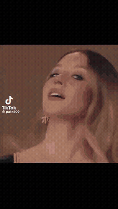 A Man Is Making A Funny Face While Sitting In A Stadium . GIF