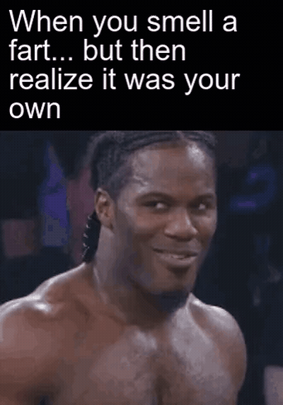 A Man Is Making A Funny Face While Smelling A Fart . GIF