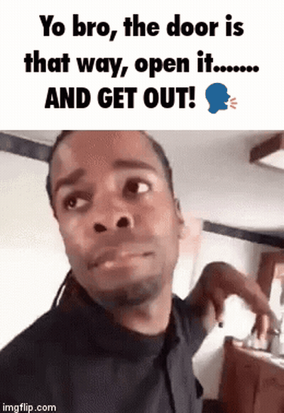 A Man Is Making A Funny Face While Standing In Front Of A Door . GIF
