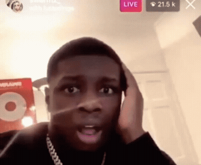 A Man Is Making A Funny Face While Talking On A Phone . GIF