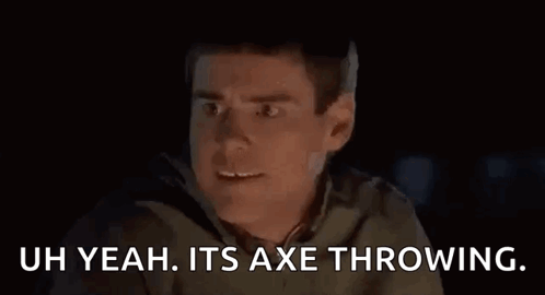 A Man Is Making A Funny Face While Throwing An Axe At The Camera . GIF