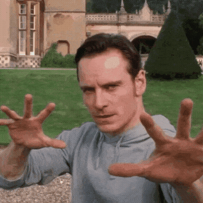 A Man Is Making A Funny Face With His Hands In The Air . GIF