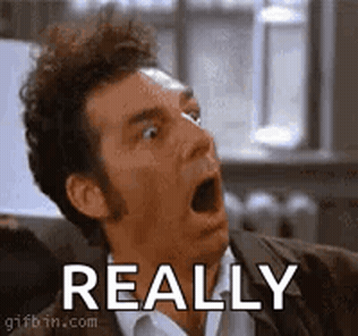 A Man Is Making A Funny Face With His Mouth Open And The Word Really Behind Him . GIF