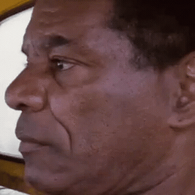 A Man Is Making A Funny Face With His Mouth Open . GIF