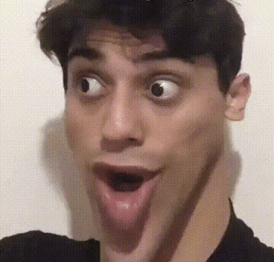 A Man Is Making A Funny Face With His Tongue Out GIF