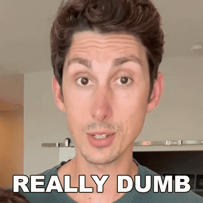 A Man Is Making A Funny Face With The Words " Really Dumb " Behind Him GIF