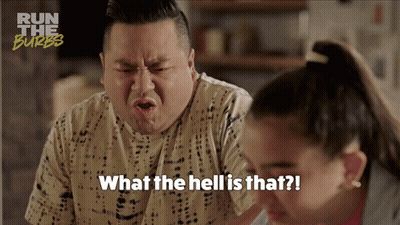 A Man Is Making A Funny Face With The Words What The Hell Is That Written Below Him GIF