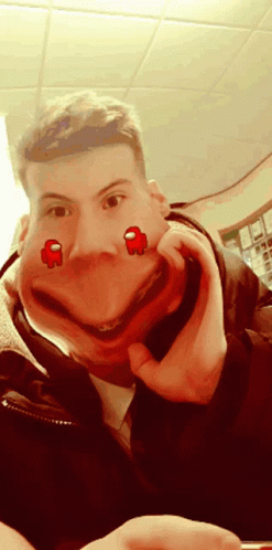A Man Is Making A Funny Face With Two Red Among Us Characters On His Face GIF