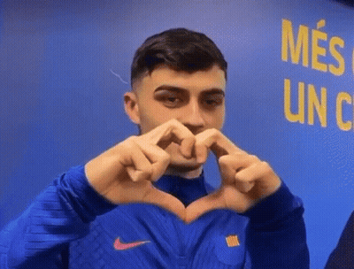 A Man Is Making A Heart Shape With His Hands . GIF