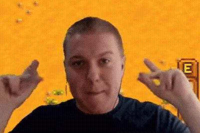 A Man Is Making A Heart Shape With His Hands In Front Of A Video Game Screen . GIF