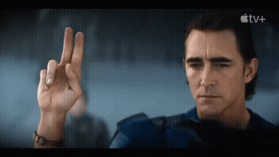 A Man Is Making A Peace Sign In Front Of An Apple Tv Logo GIF