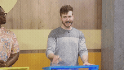 A Man Is Making A Silence Gesture With His Finger On His Lips GIF