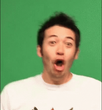 A Man Is Making A Surprised Face In Front Of A Green Background . GIF