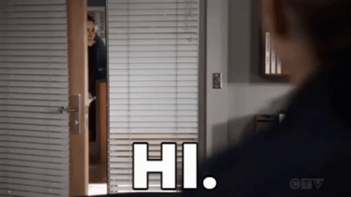 A Man Is Peeking Out From Behind A Door With Blinds And Says Hi . GIF