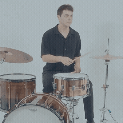 A Man Is Playing A Drum Set With A Remo Drum Head GIF