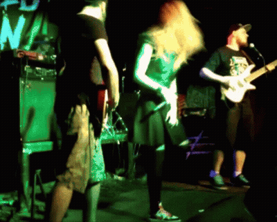 A Man Is Playing A Guitar And A Woman Is Singing GIF