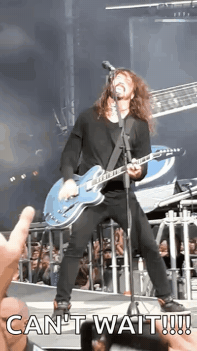 A Man Is Playing A Guitar And Singing Into A Microphone With The Words Can 'T Wait Written Below Him GIF