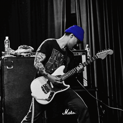 A Man Is Playing A Guitar In Front Of A Marshall Amp GIF