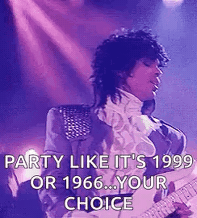A Man Is Playing A Guitar On A Stage . GIF